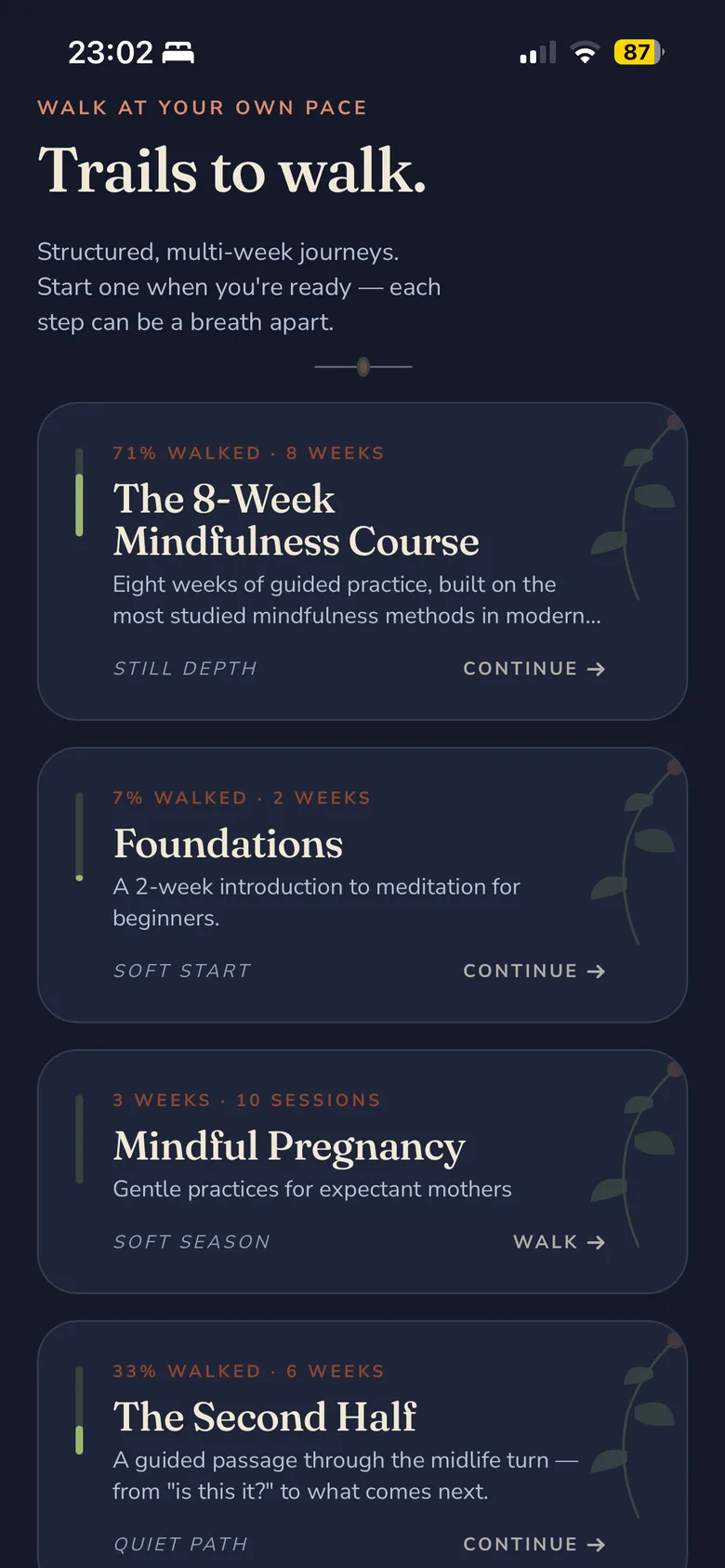 Stillee's programs screen on iPhone, eyebrow 'WALK AT YOUR OWN PACE' and title 'Trails to walk.', listing several multi-week paths with progress bars and 'continue' shortcuts, each tagged with a quiet mood word like 'still depth' or 'soft start'.
